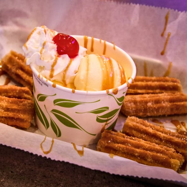 Cabo Taco's churros with vanilla ice cream, whipped cream, cherry, and caramel drizzle.